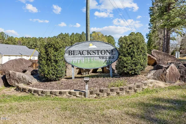 wooden floor fireplace and windows in an empty room