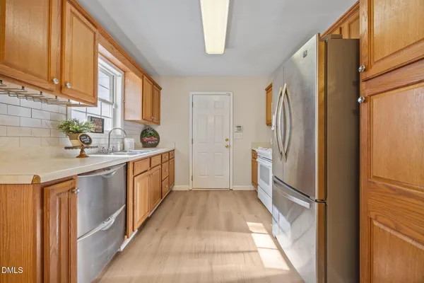 an empty room with wooden floor and a window