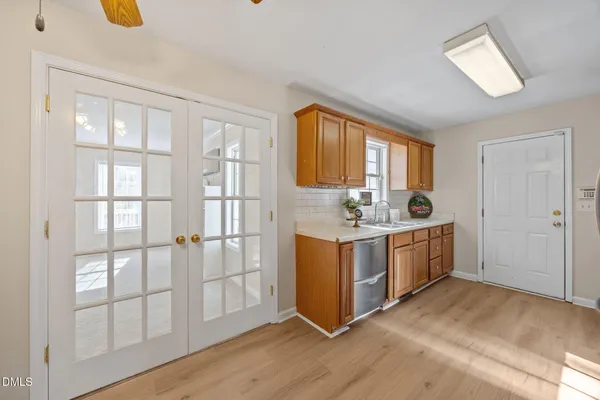 a kitchen with stainless steel appliances granite countertop a refrigerator a sink and dishwasher