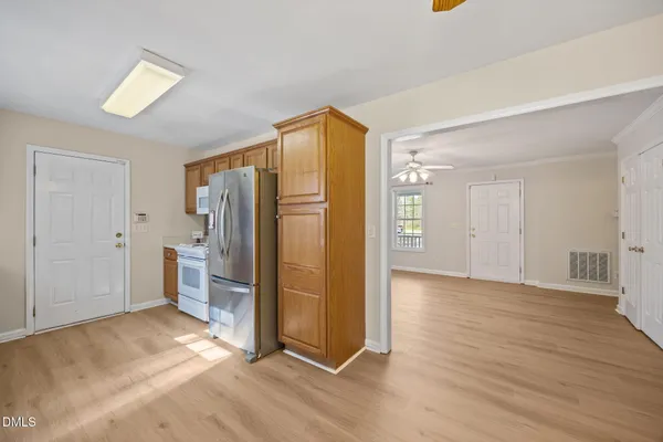 a view of an empty room with a ceiling fan