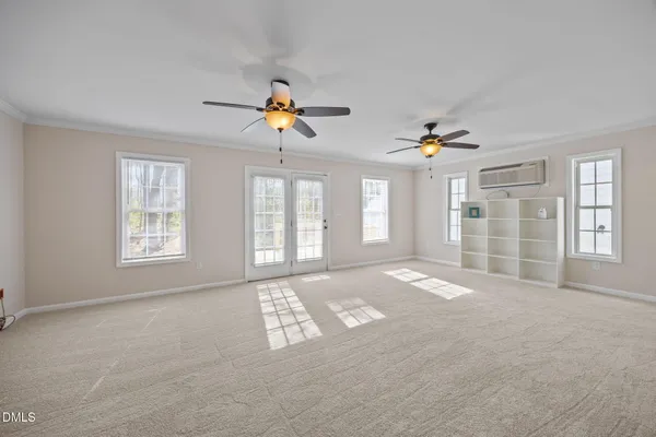 a view of an empty room with closet and workspace
