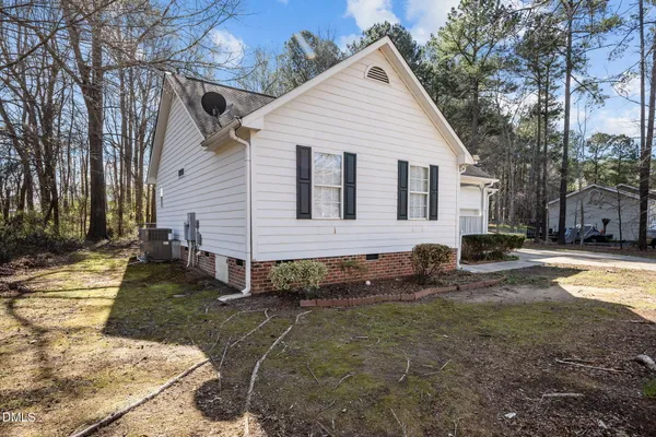 a view of a white house with a yard covered in snow
