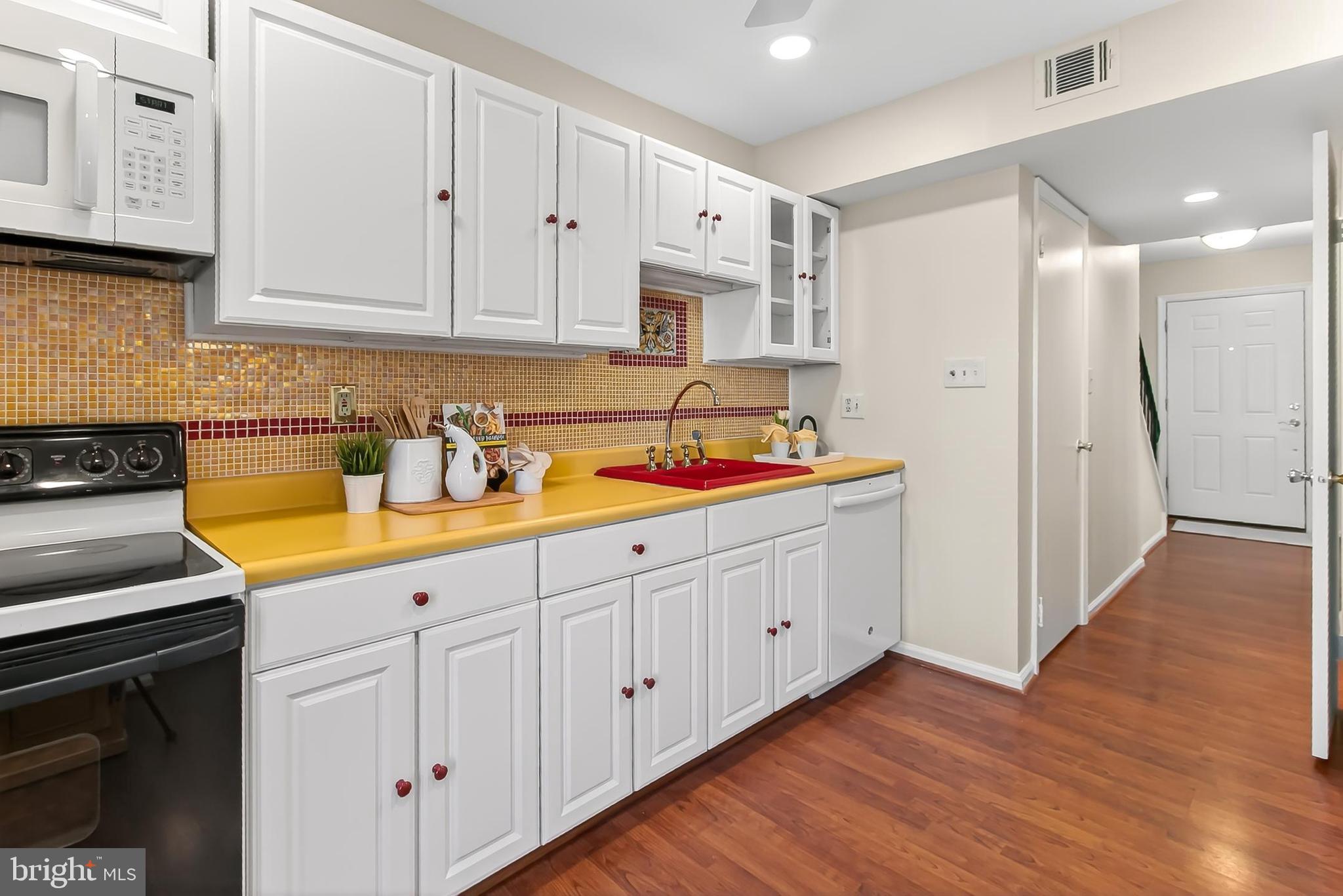 2810 Andiron Lane Vienna, VA 22180 - Photo 13 of 37 a kitchen with white cabinets and sink