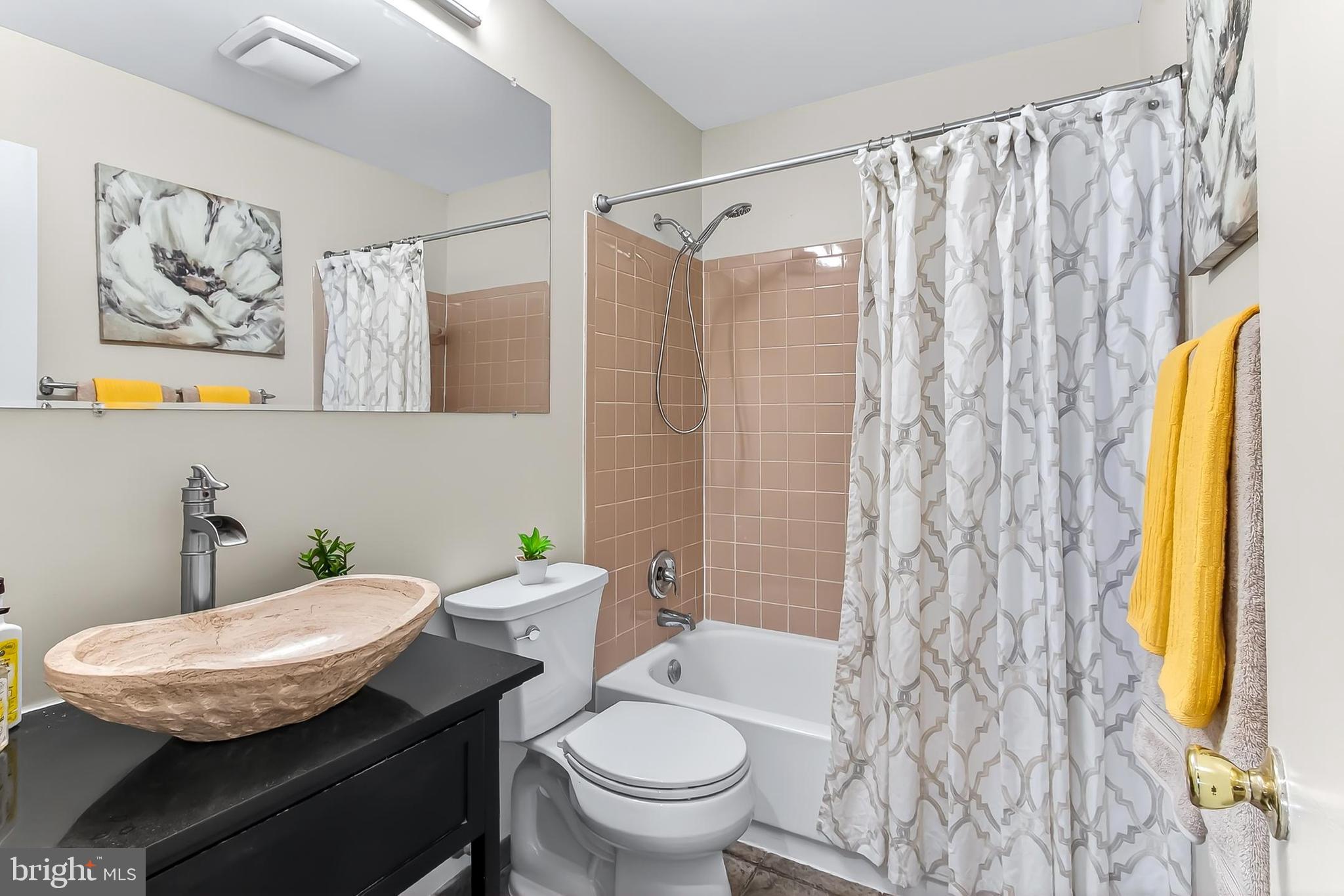 2810 Andiron Lane Vienna, VA 22180 - Photo 23 of 37 a bathroom with a granite countertop toilet a sink and a shower curtain