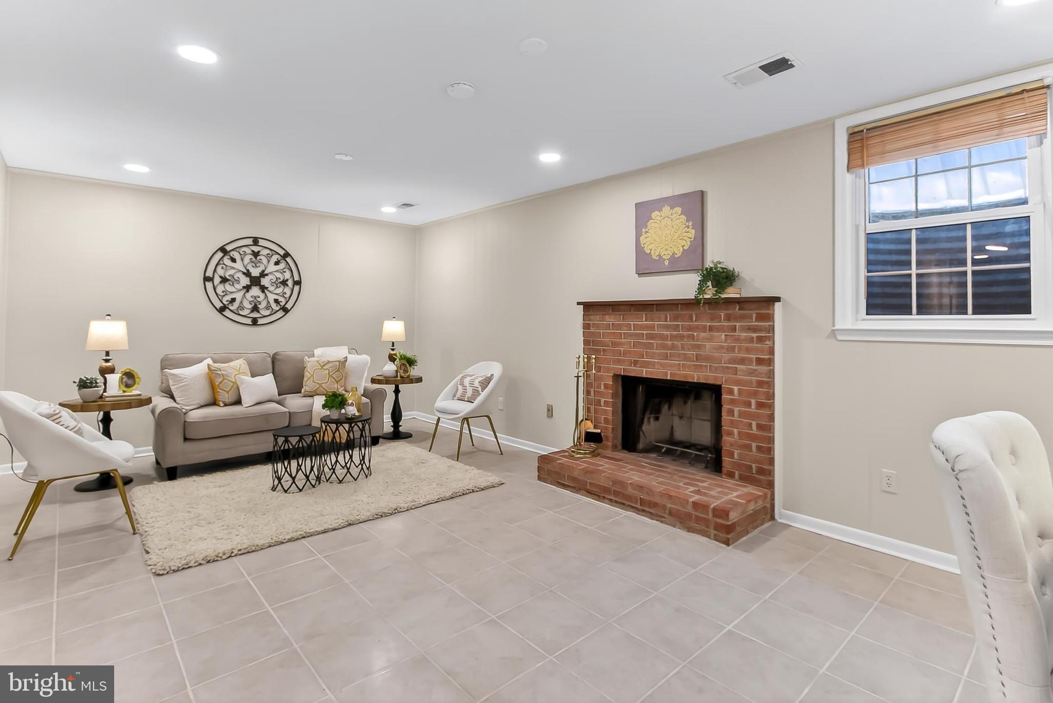 2810 Andiron Lane Vienna, VA 22180 - Photo 25 of 37 a living room with furniture a window and a fireplace