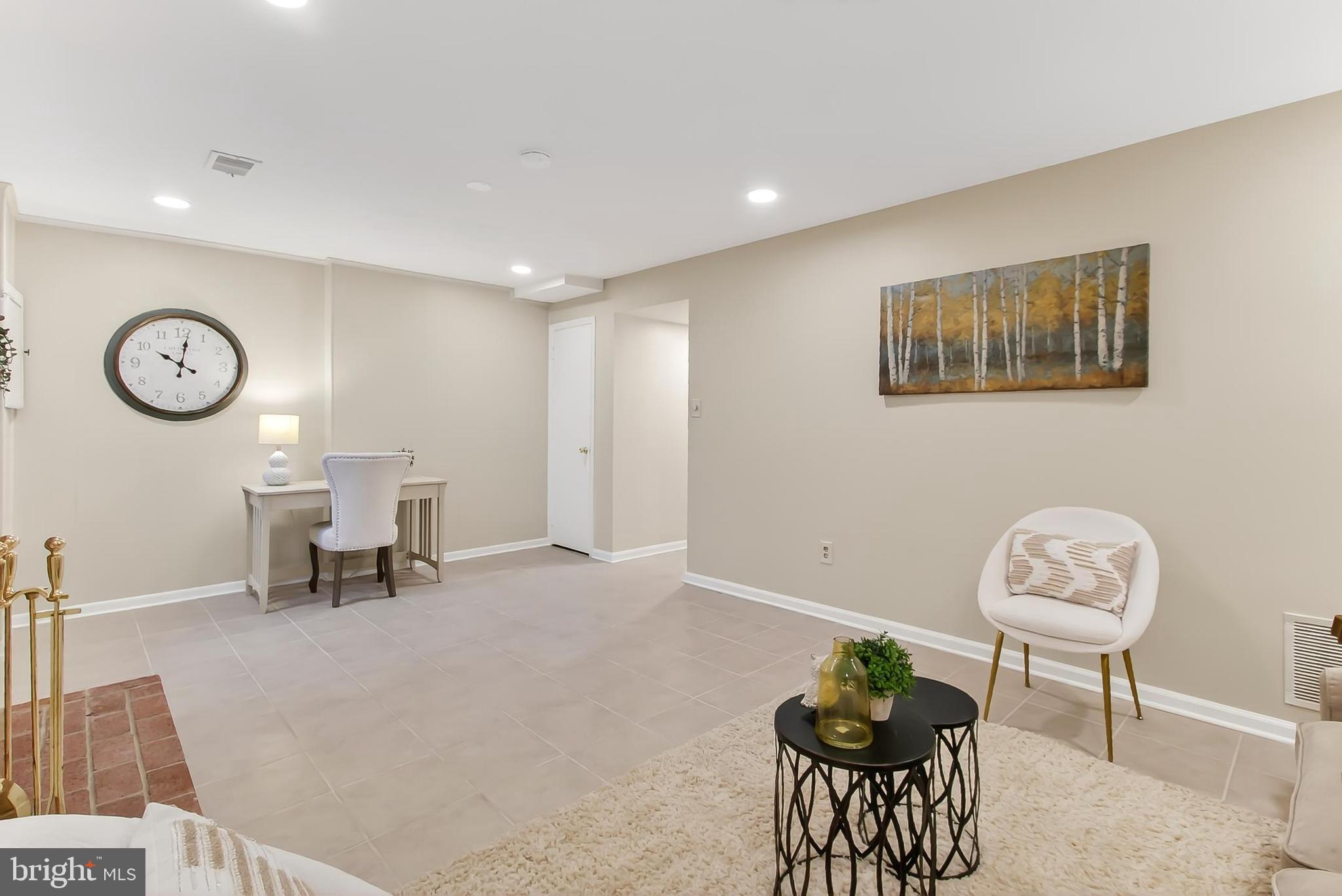 2810 Andiron Lane Vienna, VA 22180 - Photo 27 of 37 a living room with furniture a clock and a table