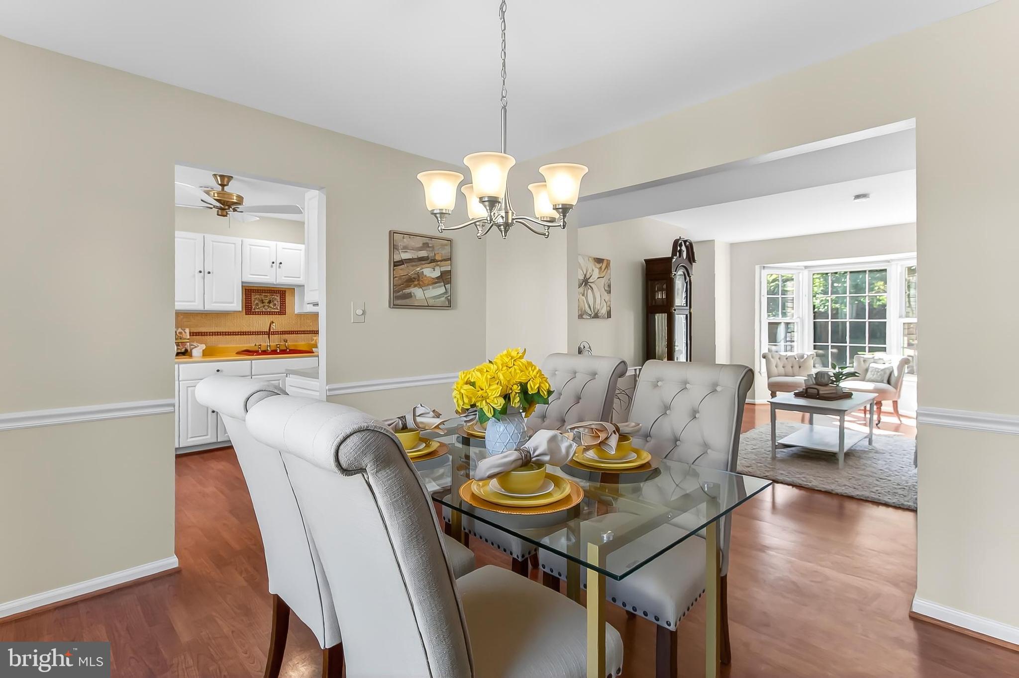 2810 Andiron Lane Vienna, VA 22180 - Photo 10 of 37 a view of a dining room with furniture a chandelier and wooden floor