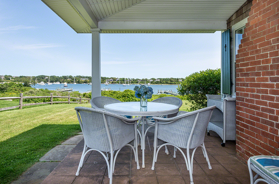 44 Green Hollow Road Edgartown, MA 02539 - Photo 11 of 45 a table and chairs with the view of garden