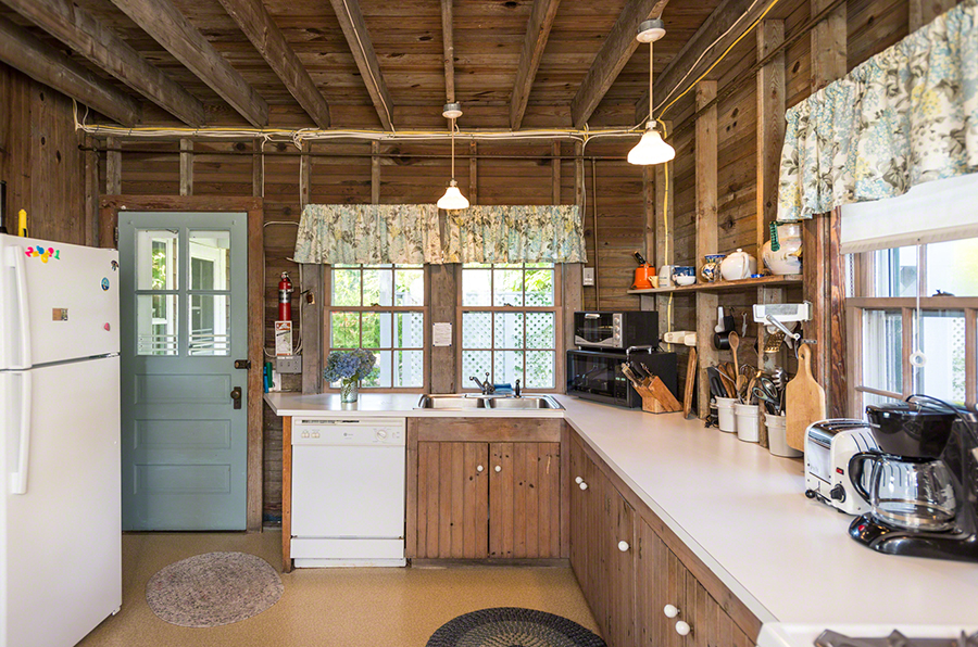 44 Green Hollow Road Edgartown, MA 02539 - Photo 22 of 45 a kitchen with a sink and wooden cabinets