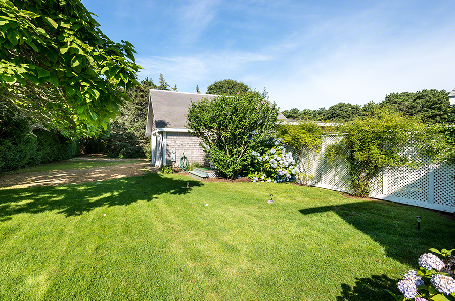 44 Green Hollow Road Edgartown, MA 02539 - Photo 40 of 45 a view of a yard with plants and a large tree