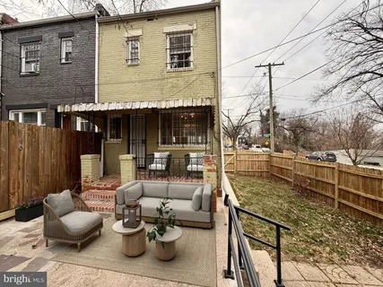 a view of a patio with couches and potted plants