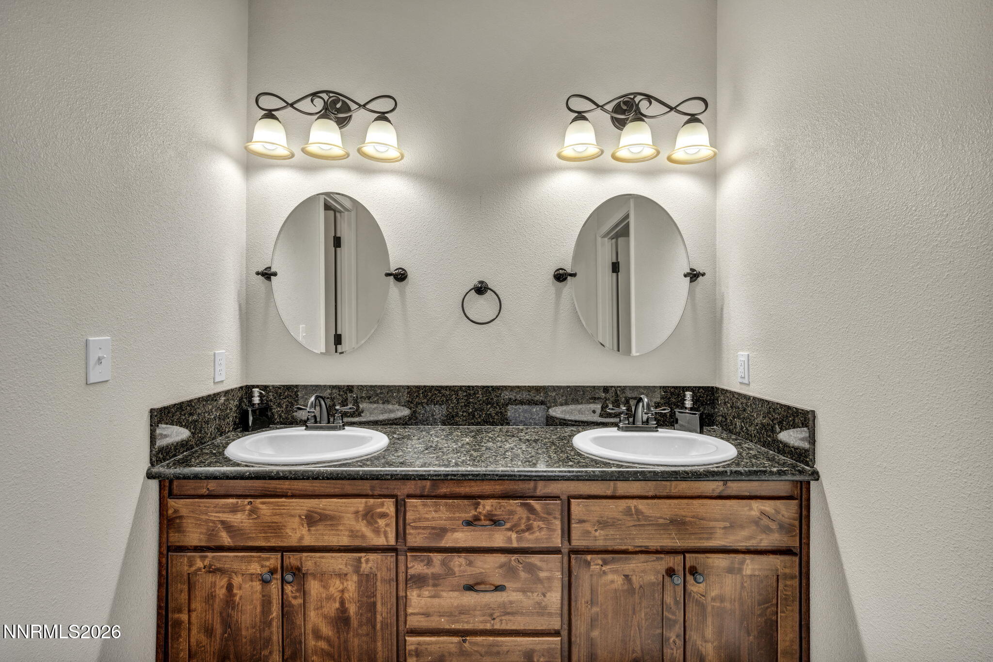 1286 Sky Ridge Drive Fallon, NV 89406 - Photo 27 of 49 a bathroom with double vanity sinks and a mirror