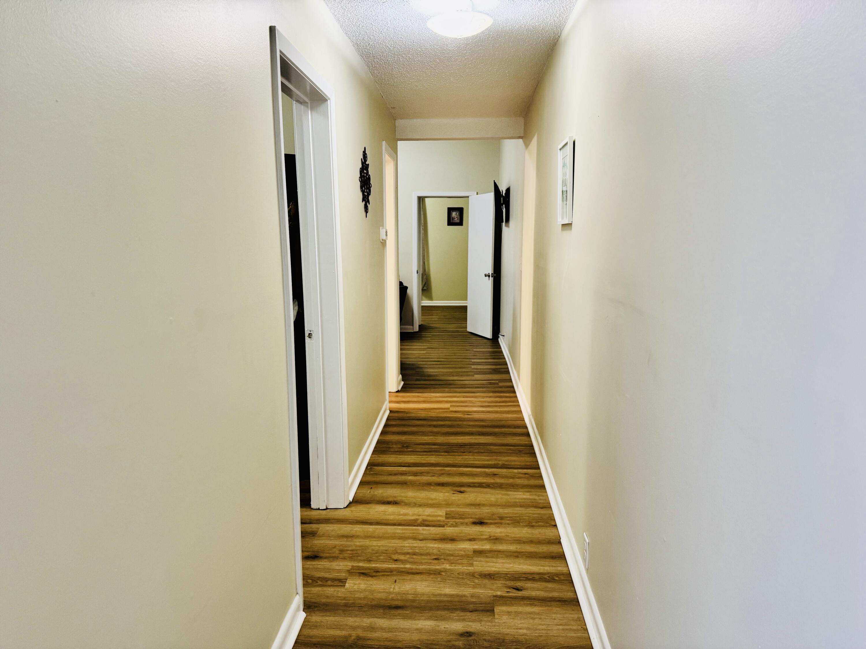 472 Claxton Avenue Elba, AL 36323 - Photo 11 of 29 a view of a hallway with wooden floor