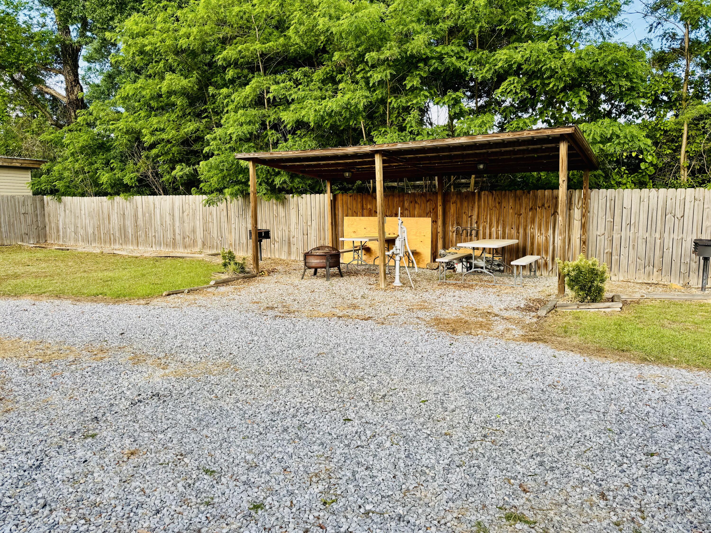 472 Claxton Avenue Elba, AL 36323 - Photo 15 of 29 a backyard of a house with barbeque oven and trees