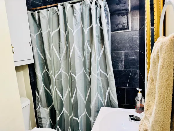 a bathroom with a shower and a sink