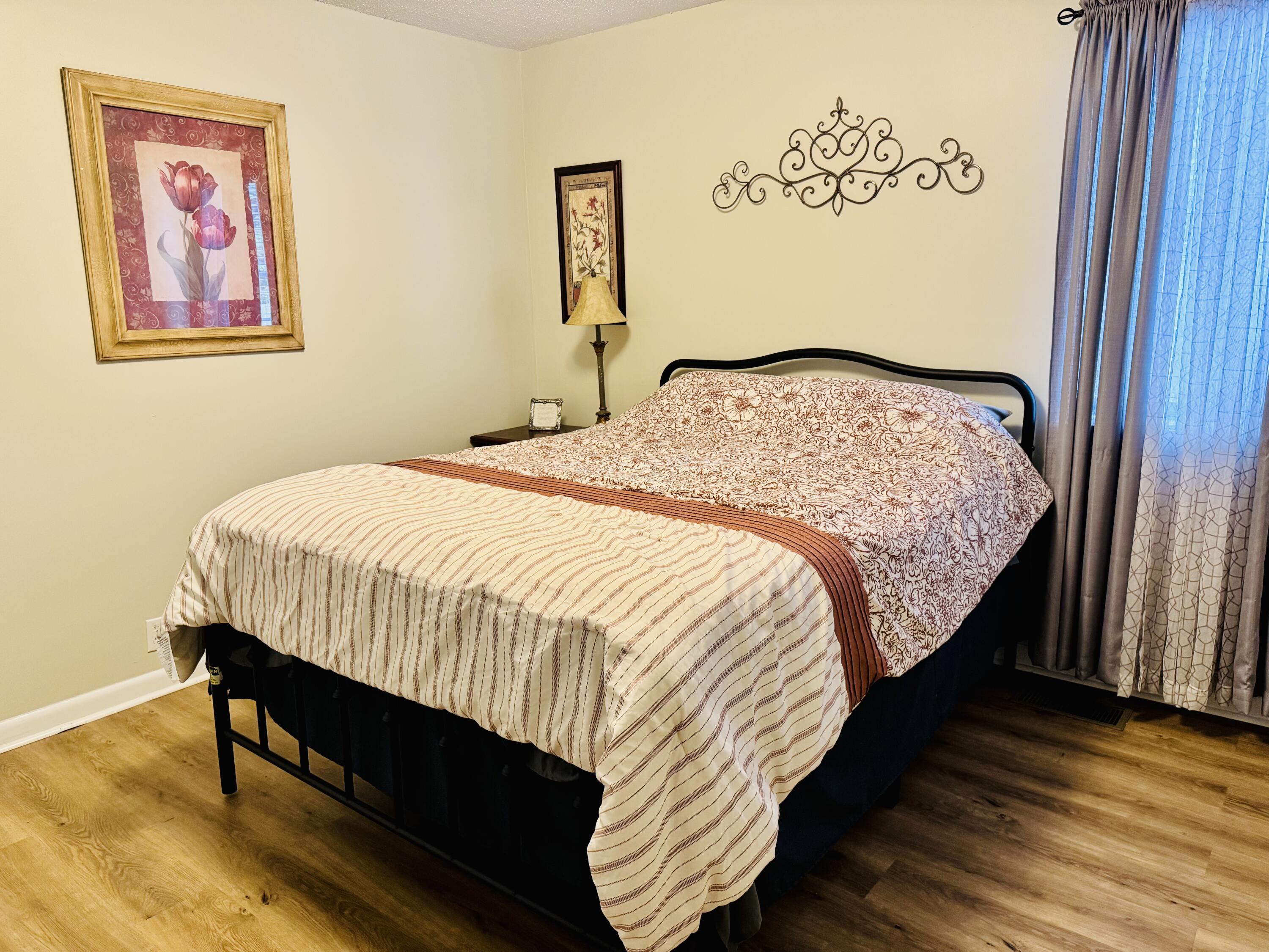 472 Claxton Avenue Elba, AL 36323 - Photo 23 of 29 a bedroom with bed and wooden floor