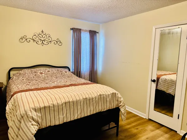 a bedroom with a bed and a mirror