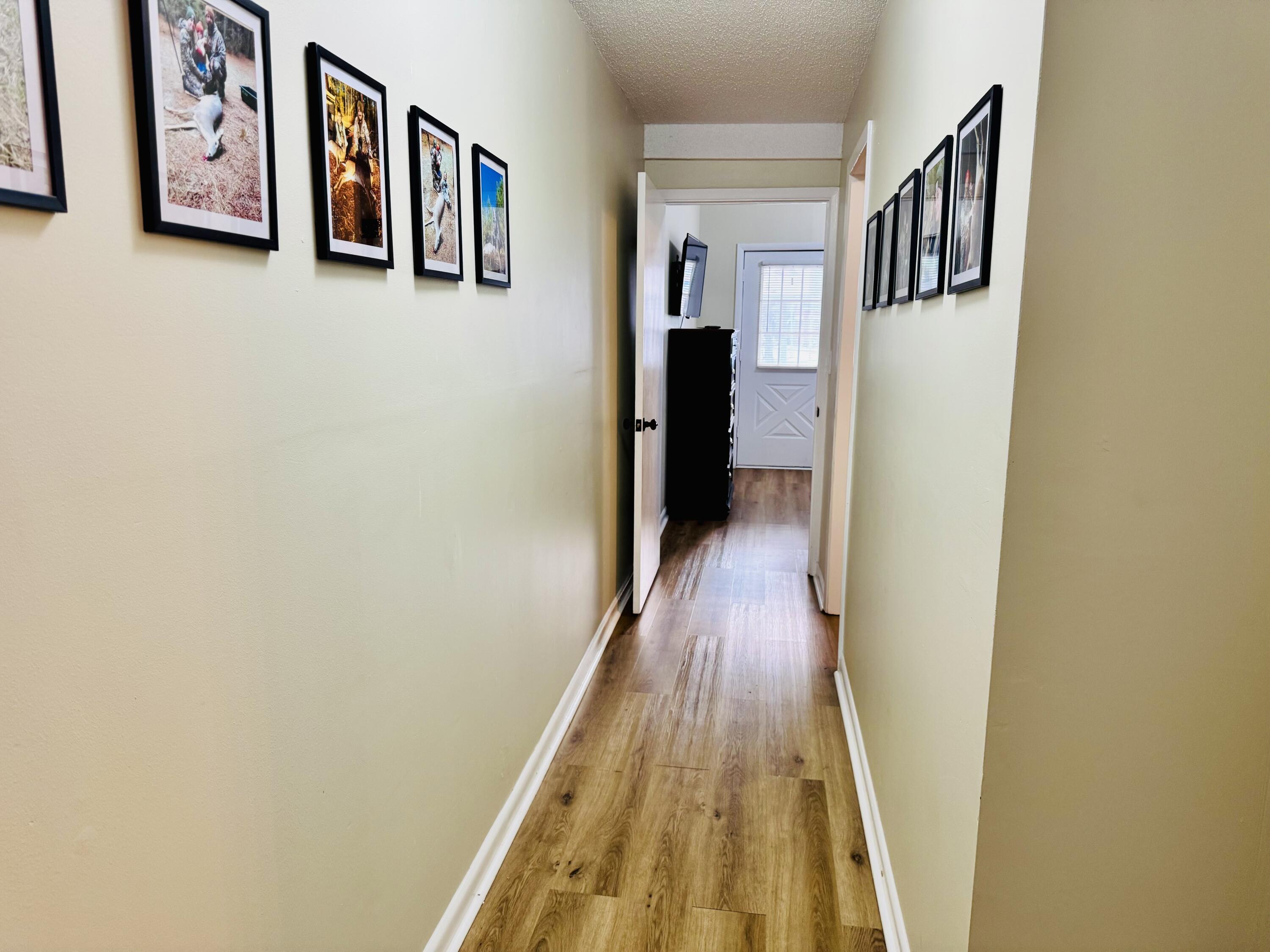 472 Claxton Avenue Elba, AL 36323 - Photo 26 of 29 a view of a hallway with wooden floor and closet