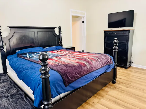 a bedroom with a bed and a television