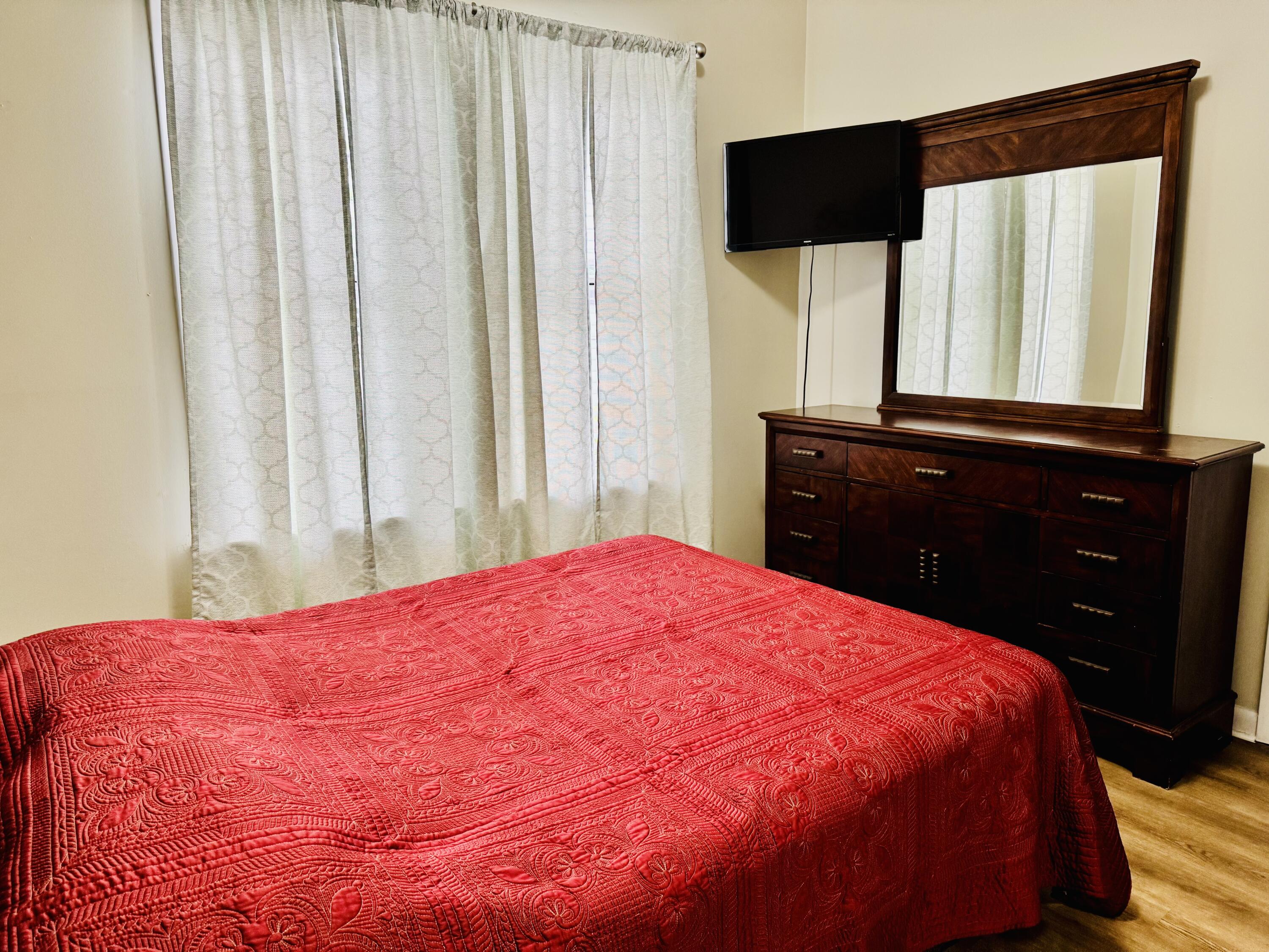 472 Claxton Avenue Elba, AL 36323 - Photo 3 of 29 a large bed sitting in a bedroom next to a window