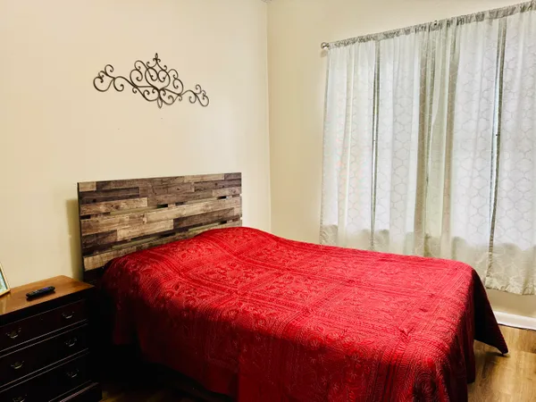 a bedroom with a bed and a window