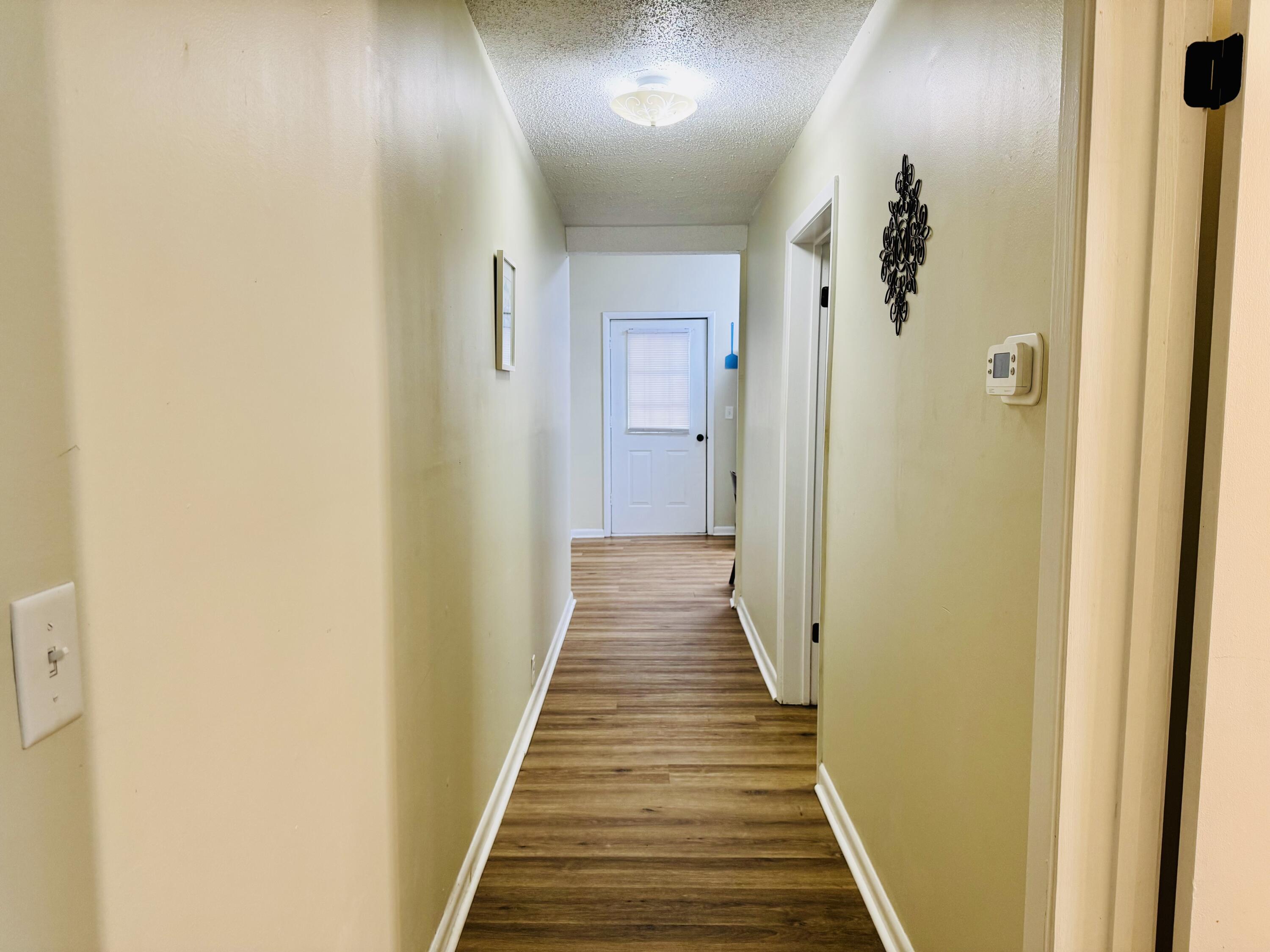 472 Claxton Avenue Elba, AL 36323 - Photo 10 of 29 a view of a hallway with wooden floor and staircase