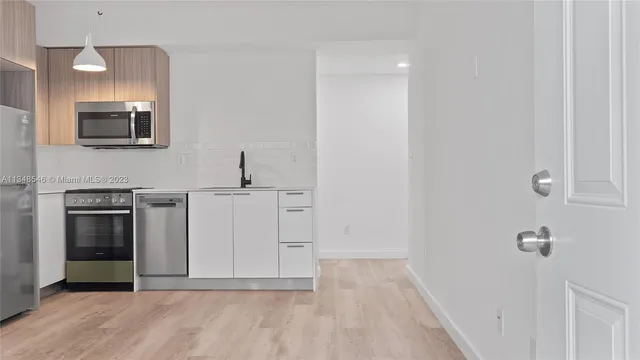 a view of a sink storage and utility room in a house