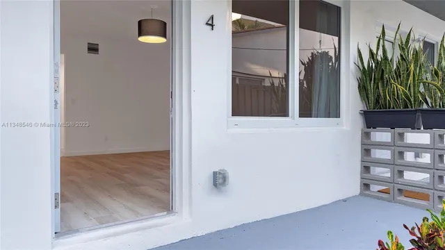 a view of a kitchen with a sink and a refrigerator