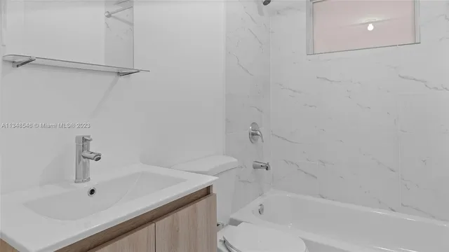 a view of a room with wooden floor and a window