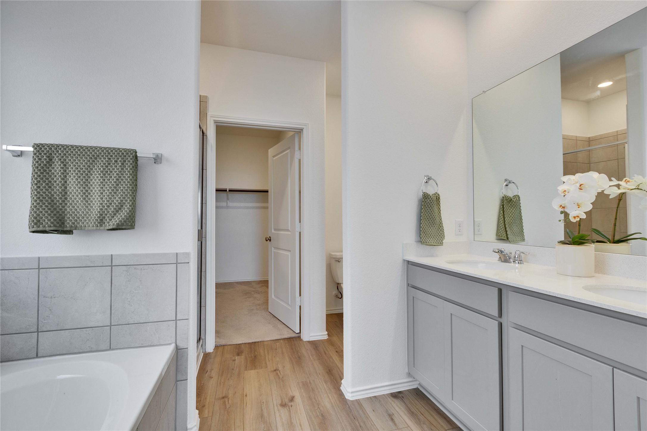 206 Canley Loop Hutto, TX 78634 - Photo 3 of 31 Full bath in primary with a glass stall shower and bathtub.
