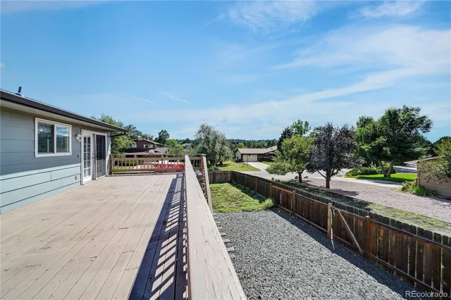 a view of a wooden deck and city view
