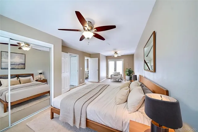 a bedroom with a bed mirror and window