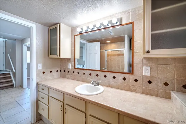 a bathroom with a sink double vanity and a mirror