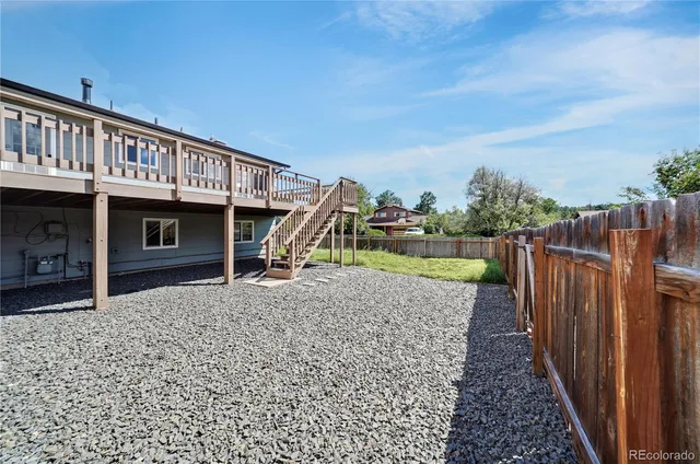 a view of a house with a wooden deck