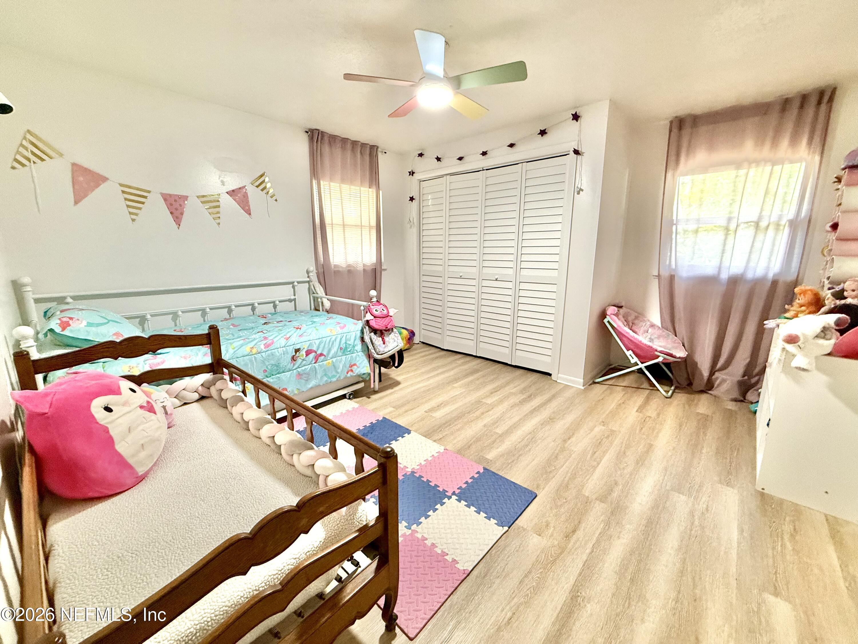 1953 Bartram Road Jacksonville, FL 32207 - Photo 11 of 25 a bedroom with furniture and a wooden floor