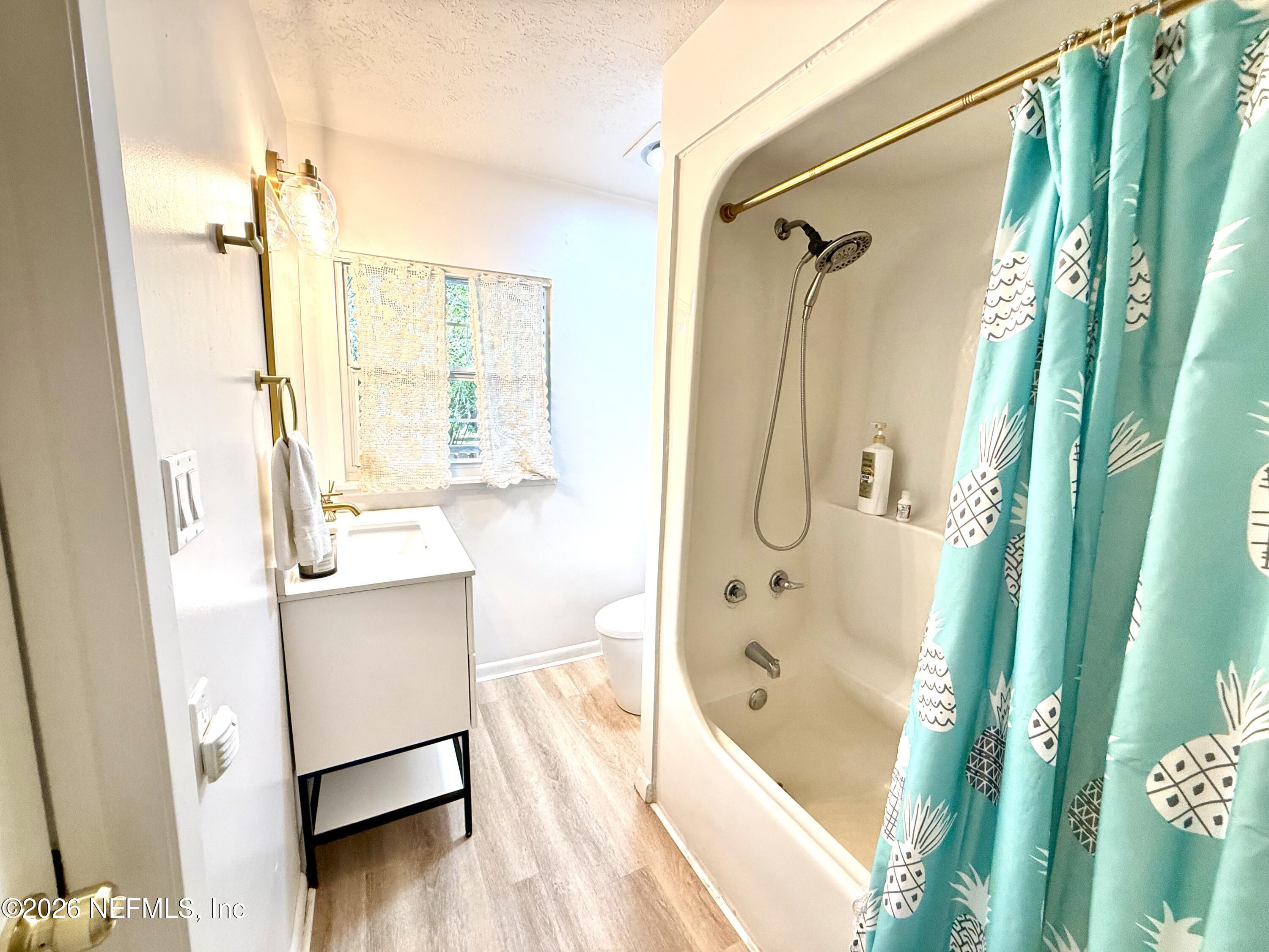 1953 Bartram Road Jacksonville, FL 32207 - Photo 12 of 25 a bathroom with a tub shower and sink