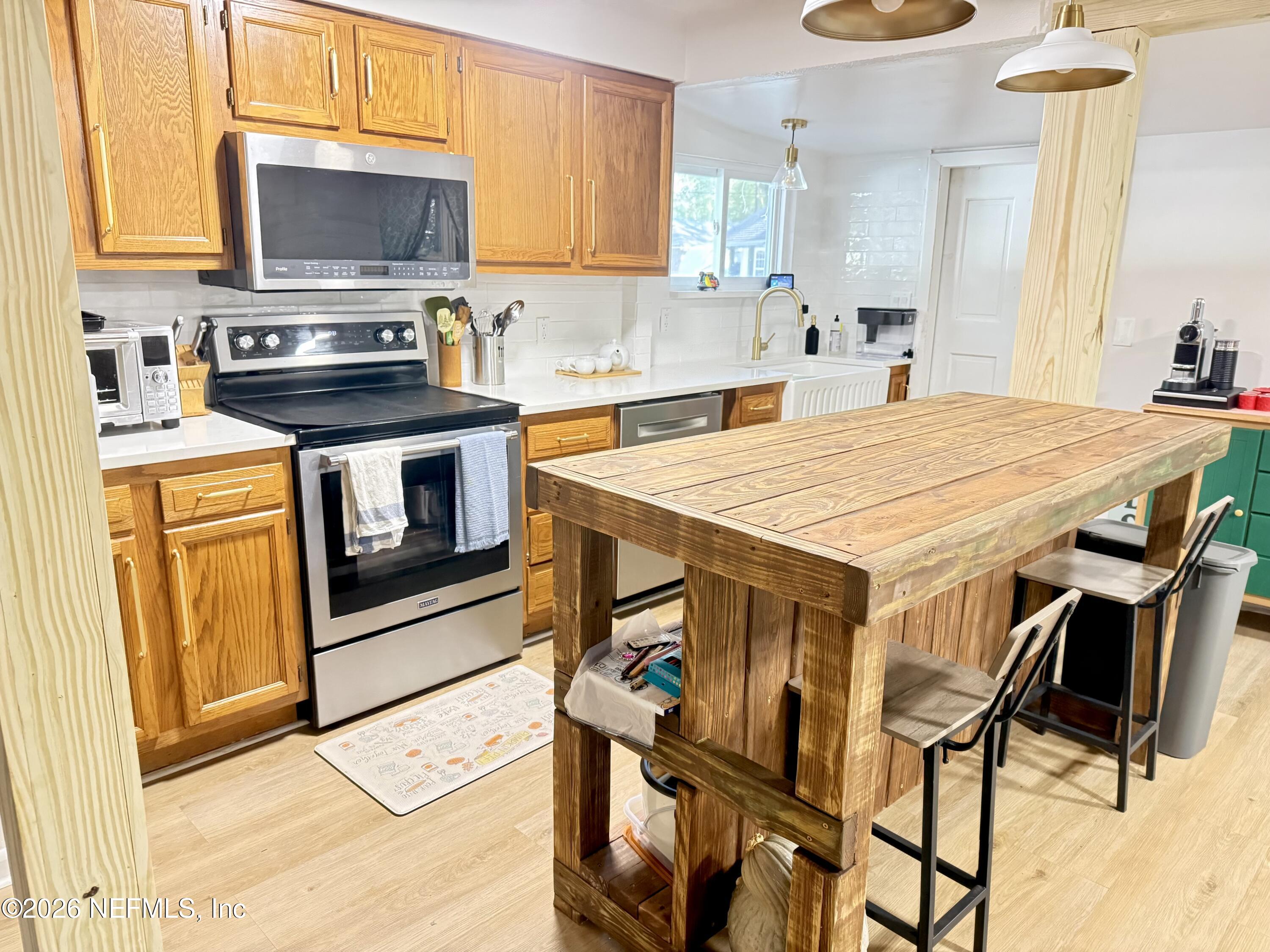 1953 Bartram Road Jacksonville, FL 32207 - Photo 3 of 25 a kitchen with a stove a sink and a refrigerator