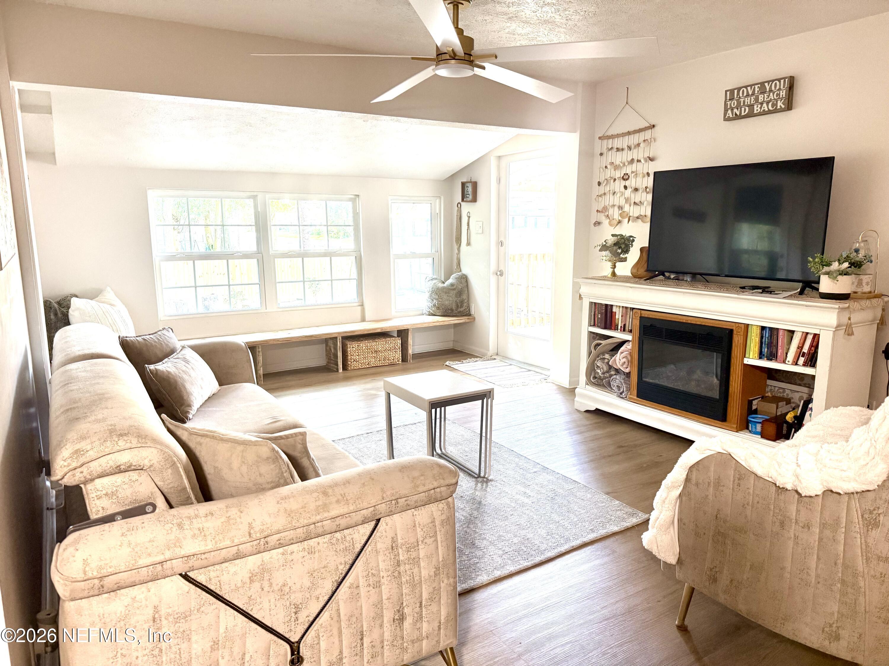 1953 Bartram Road Jacksonville, FL 32207 - Photo 4 of 25 a living room with furniture a flat screen tv and a fireplace