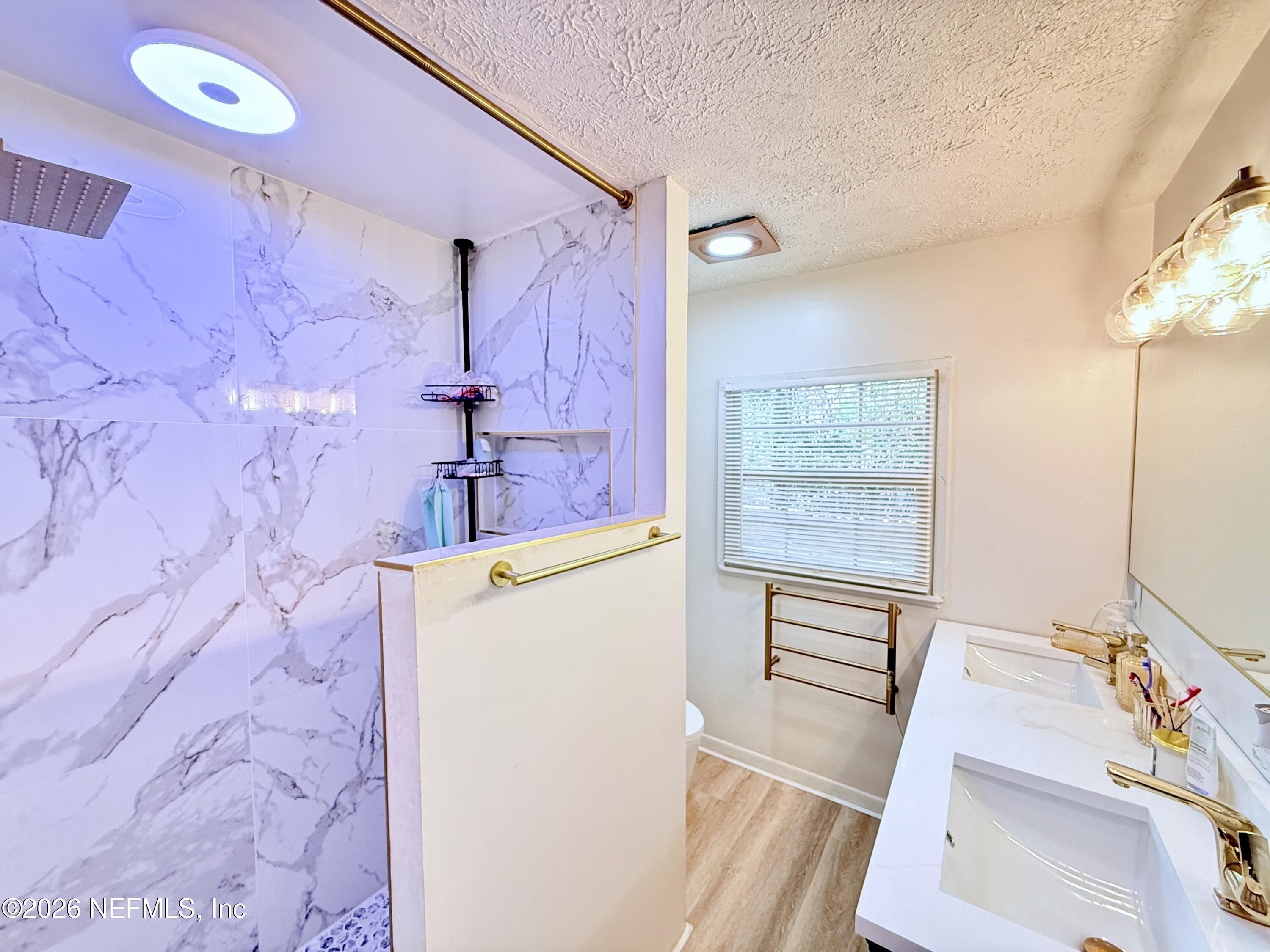 1953 Bartram Road Jacksonville, FL 32207 - Photo 10 of 25 a bathroom with a sink a vanity and a mirror