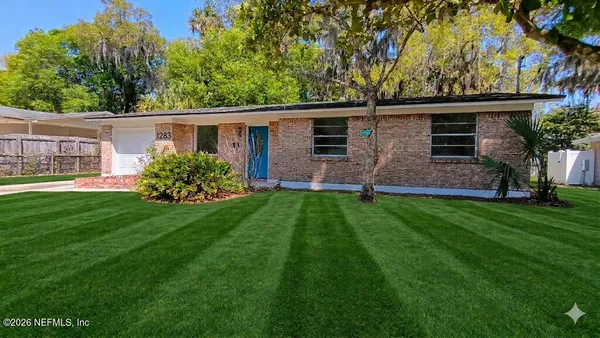 a front view of house with yard and green space