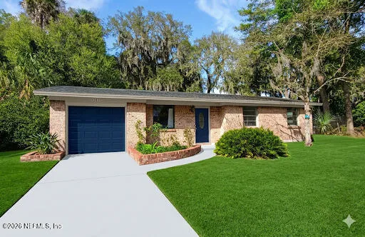 a front view of a house with a yard and porch