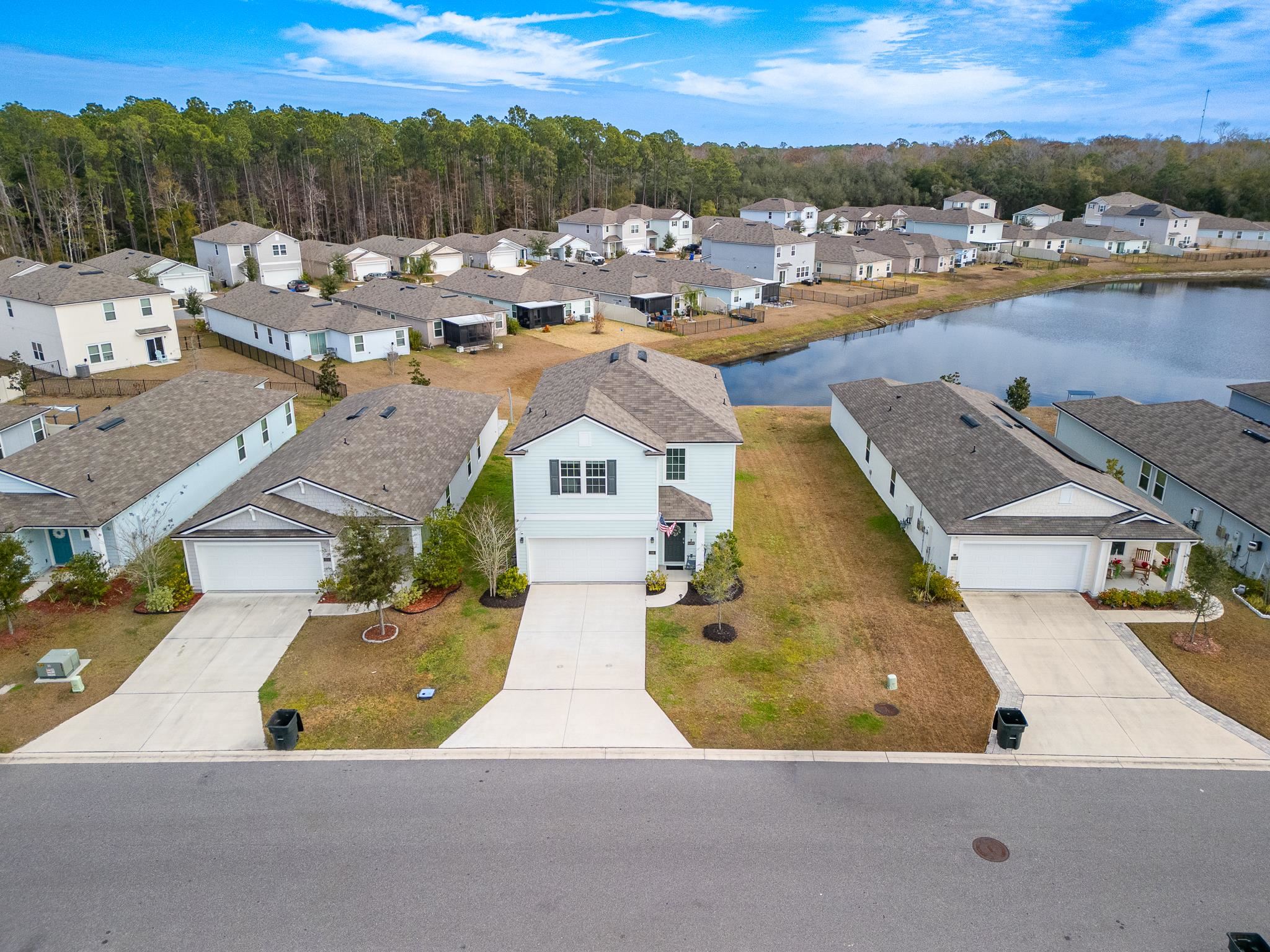 Aerial perspective of suburban area with a large body of water