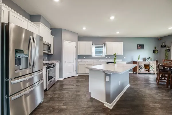 a kitchen with a sink stove and cabinets