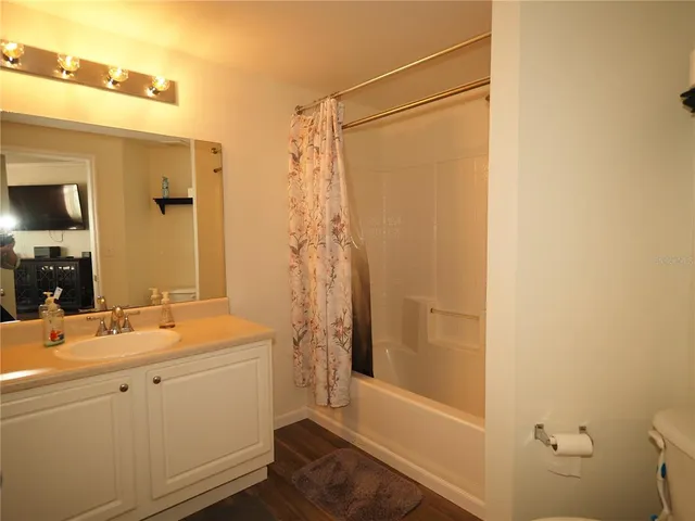 a bathroom with a sink a toilet and mirror