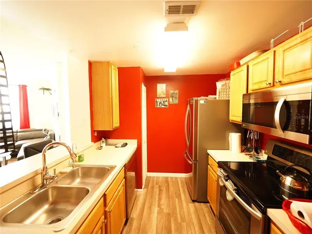 a spacious bathroom with a double vanity sink a mirror and a bathtub