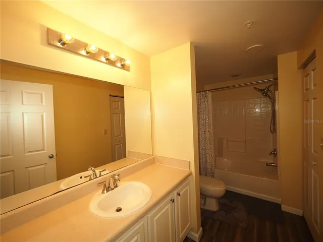 a bedroom with a bed and a television