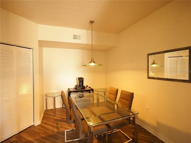 a dining room with furniture and a chandelier