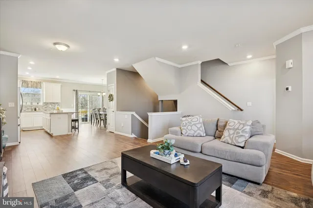 a living room with furniture and kitchen view