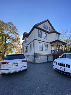 a front view of a house with parking space