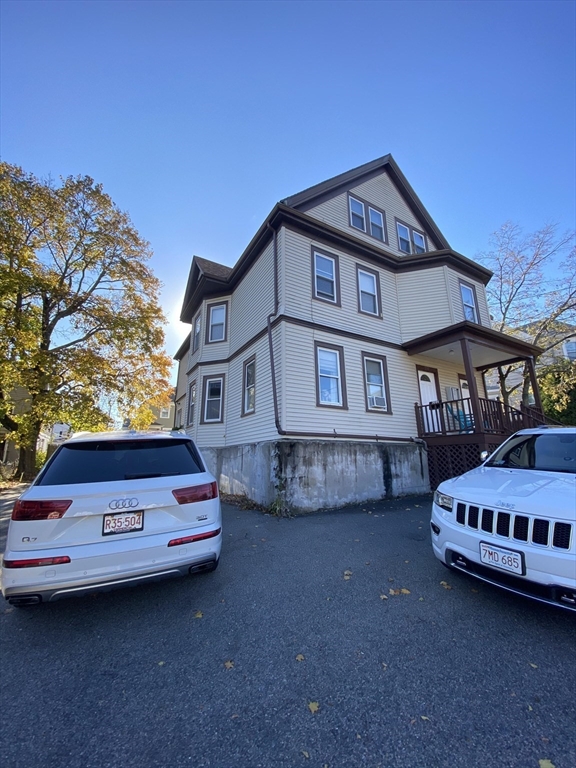 a front view of a house with parking space